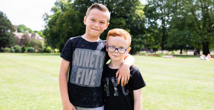 Two boys together, smiling at the camera