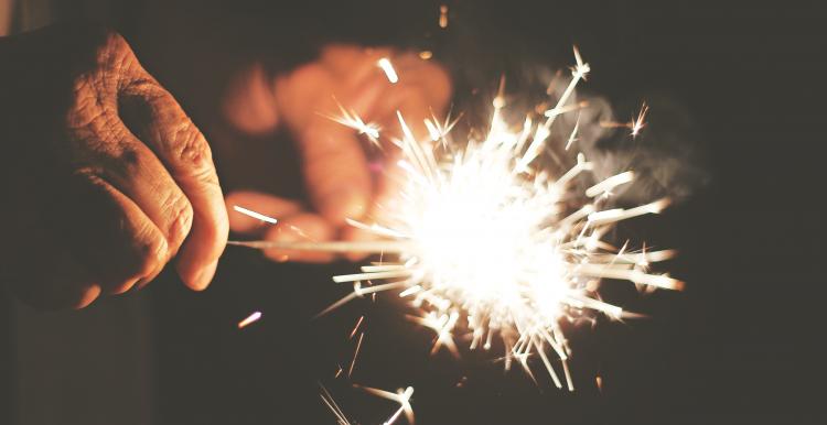 Older person holding a sparkler